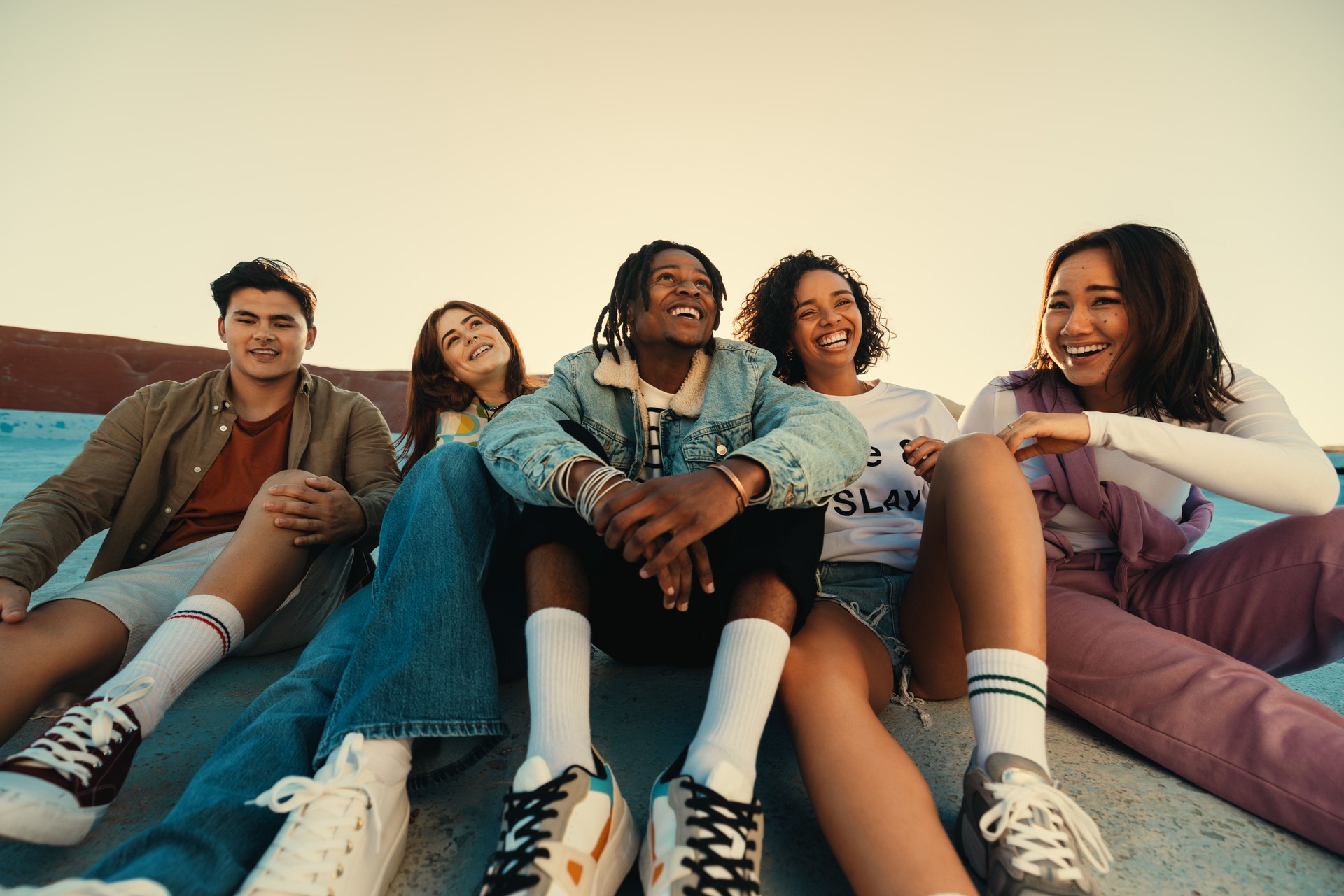 Group of friends enjoying time together outdoors, smiling and laughing